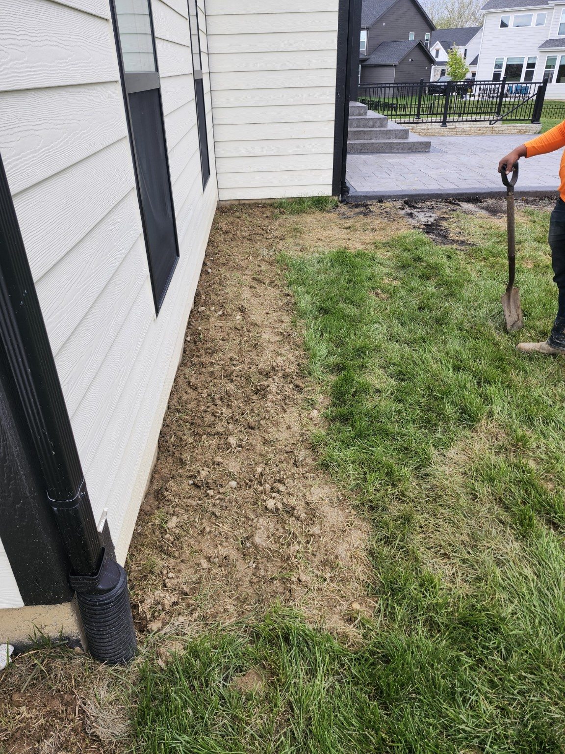 Bare strip of soil along the house.